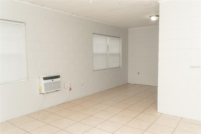 spare room with light tile patterned floors and a wall mounted AC