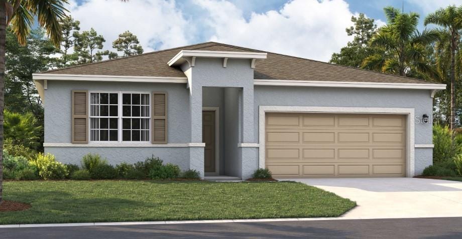 view of front of property featuring a garage and a front yard