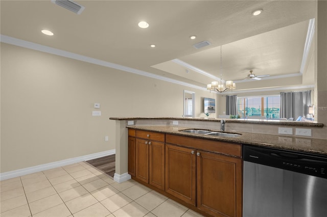 kitchen with dishwasher, ceiling fan with notable chandelier, sink, dark stone countertops, and ornamental molding