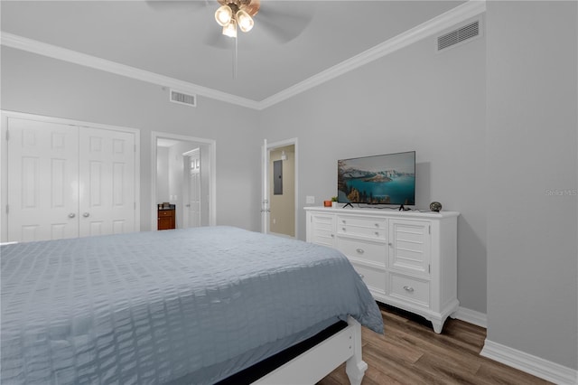 bedroom featuring hardwood / wood-style floors, a closet, ceiling fan, and ornamental molding