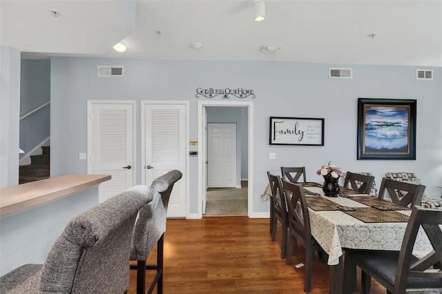 dining area featuring dark wood-type flooring