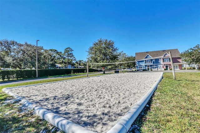 view of home's community with a lawn and volleyball court