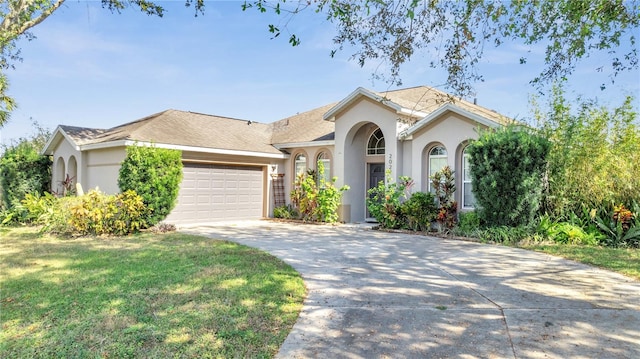 view of front facade with a front yard and a garage