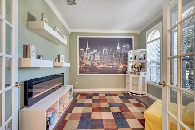 interior space featuring dark hardwood / wood-style flooring, crown molding, and french doors