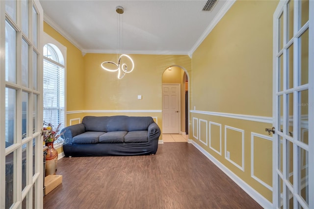 sitting room featuring hardwood / wood-style floors, french doors, and ornamental molding