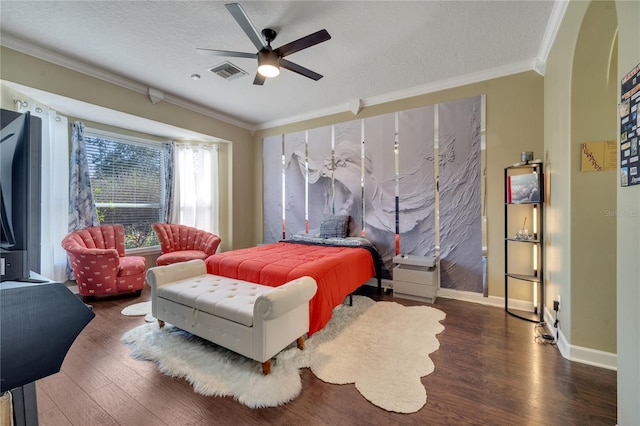 bedroom featuring a textured ceiling, dark hardwood / wood-style floors, ceiling fan, and crown molding