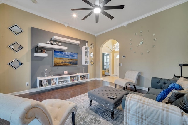 living room with ceiling fan, wood-type flooring, and ornamental molding