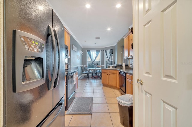 kitchen featuring sink, light tile patterned floors, black appliances, and ornamental molding