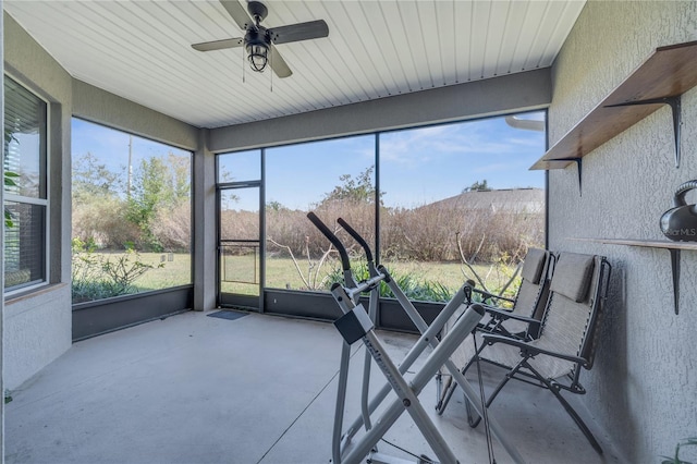 unfurnished sunroom with ceiling fan and plenty of natural light