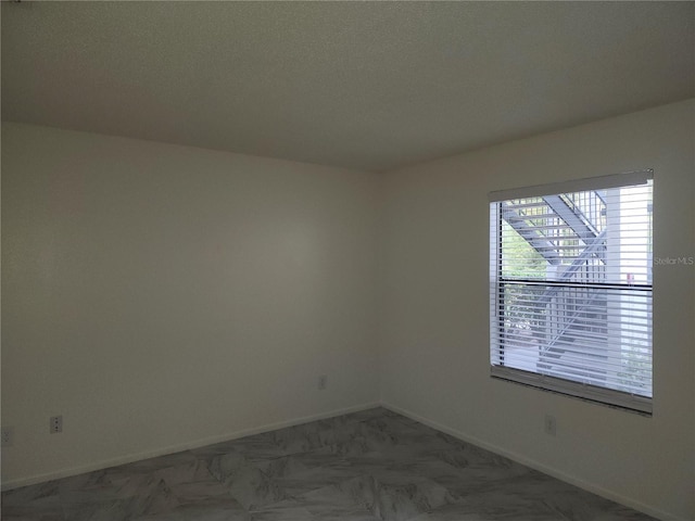 empty room featuring a textured ceiling