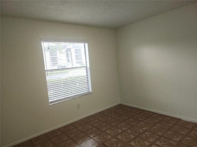 spare room featuring a textured ceiling