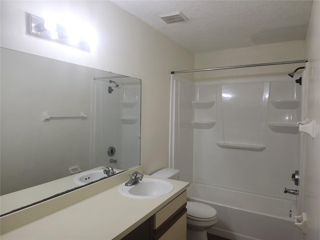 full bathroom with vanity, shower / tub combination, a textured ceiling, and toilet