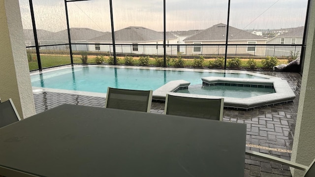 view of pool with an in ground hot tub