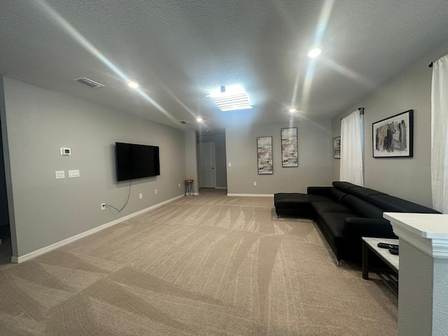 carpeted living room featuring a textured ceiling