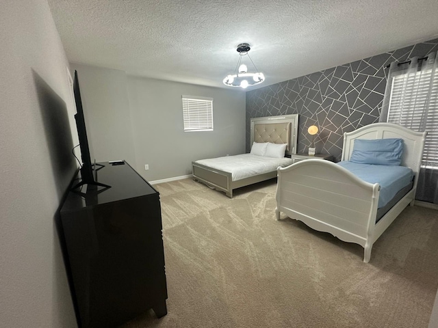 bedroom with a textured ceiling, a notable chandelier, and light carpet