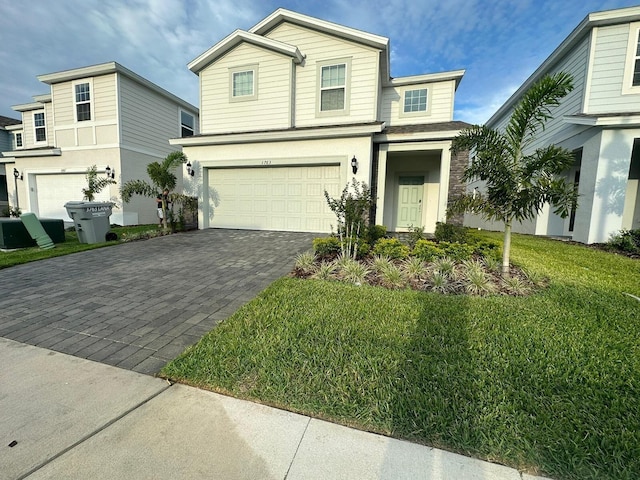 view of front of home featuring a front yard and a garage