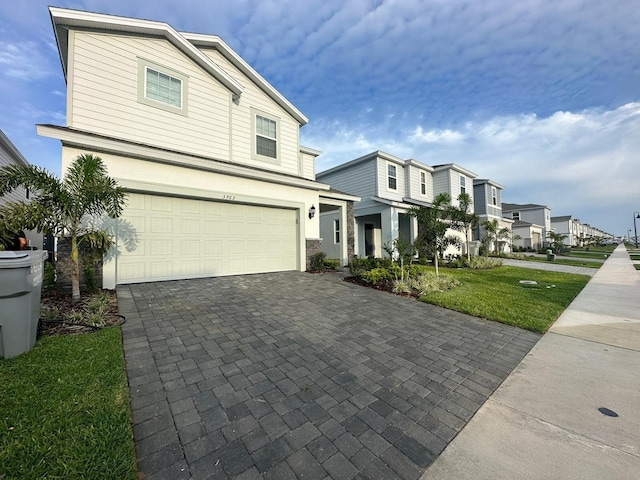 front facade with a garage and a front yard