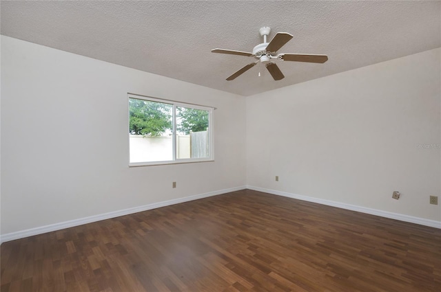 spare room with dark hardwood / wood-style floors, ceiling fan, and a textured ceiling