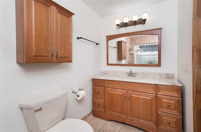 bathroom featuring tile patterned flooring, vanity, and toilet