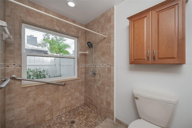 bathroom with tiled shower and toilet