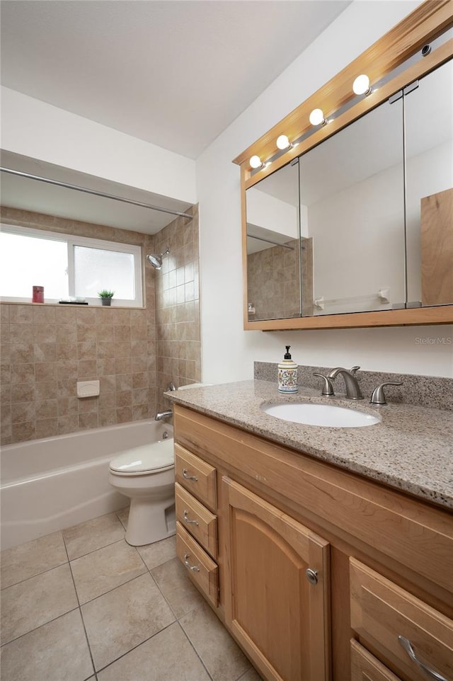 full bathroom with tile patterned floors, vanity, toilet, and tiled shower / bath