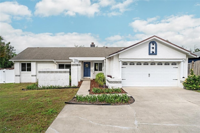 ranch-style home featuring a garage and a front lawn