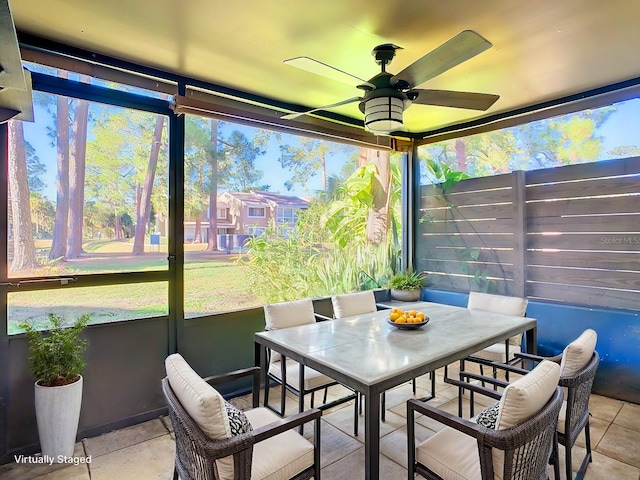 sunroom / solarium featuring ceiling fan