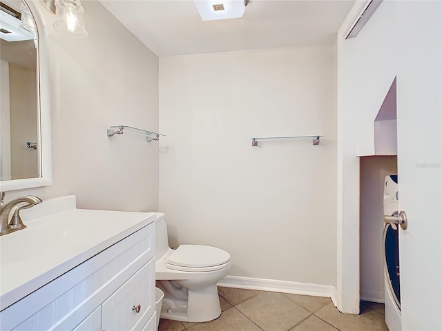 bathroom featuring tile patterned flooring, vanity, and toilet