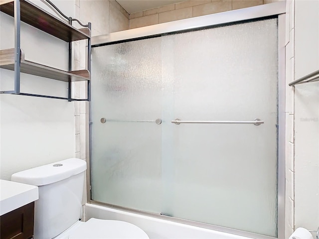 full bathroom with vanity, toilet, and bath / shower combo with glass door