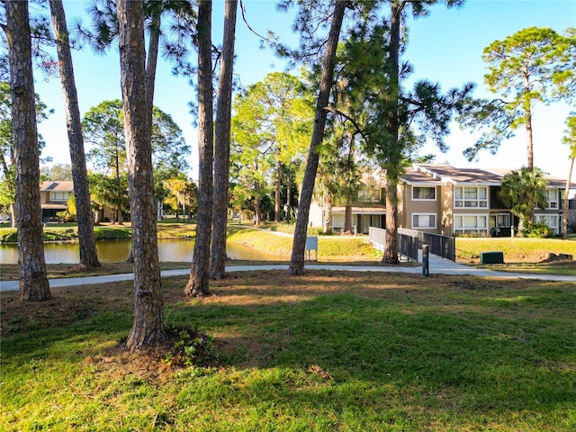 surrounding community featuring a yard and a water view