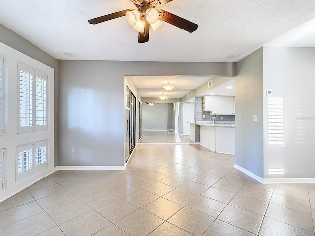 interior space featuring plenty of natural light, ceiling fan, and a textured ceiling