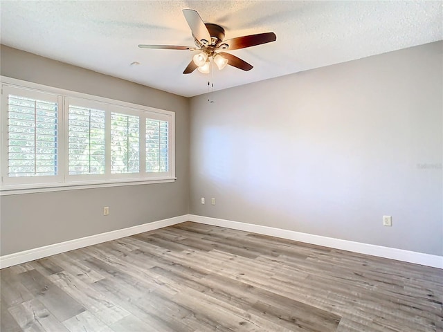 unfurnished room featuring hardwood / wood-style floors, ceiling fan, and a textured ceiling