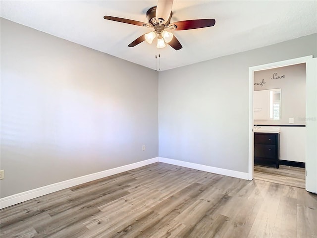 spare room featuring light hardwood / wood-style floors and ceiling fan