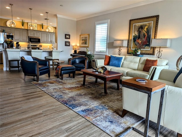 living room with sink and ornamental molding