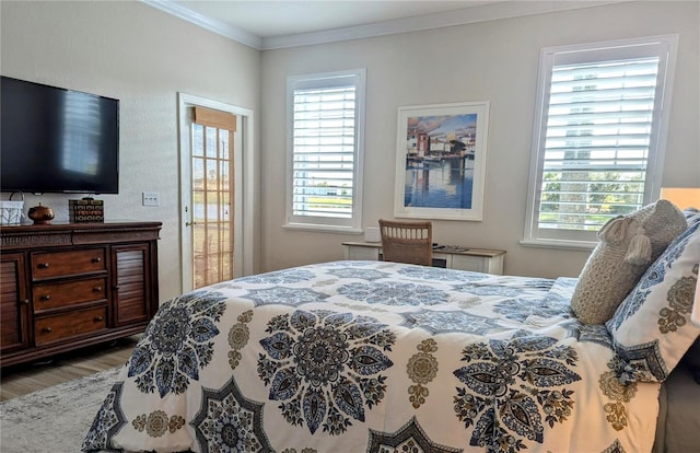 bedroom with ornamental molding and wood-type flooring