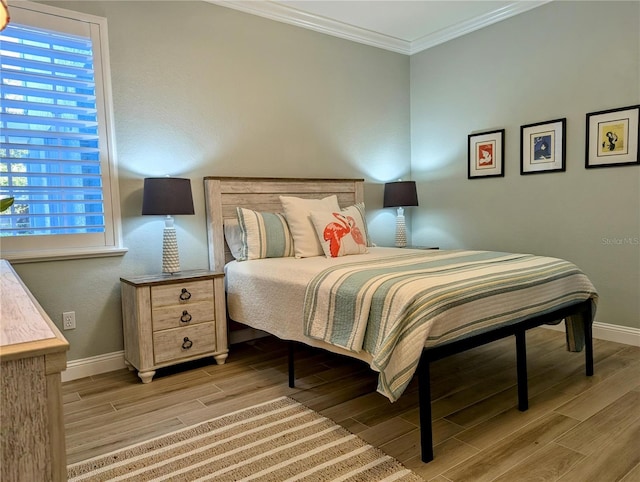 bedroom with crown molding and light hardwood / wood-style flooring