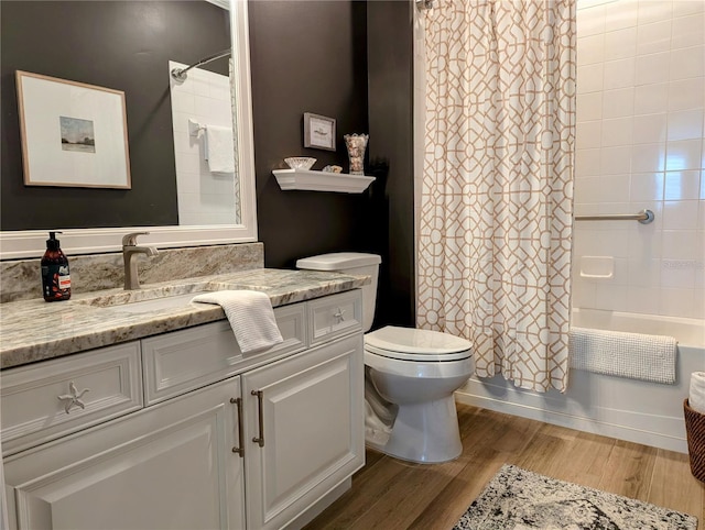 full bathroom with shower / tub combo with curtain, wood-type flooring, toilet, and vanity