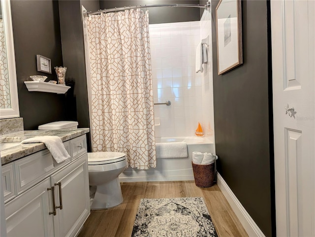 full bathroom with shower / tub combo, vanity, hardwood / wood-style flooring, and toilet