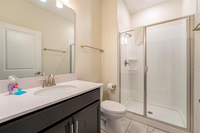 bathroom featuring vanity, toilet, and an enclosed shower