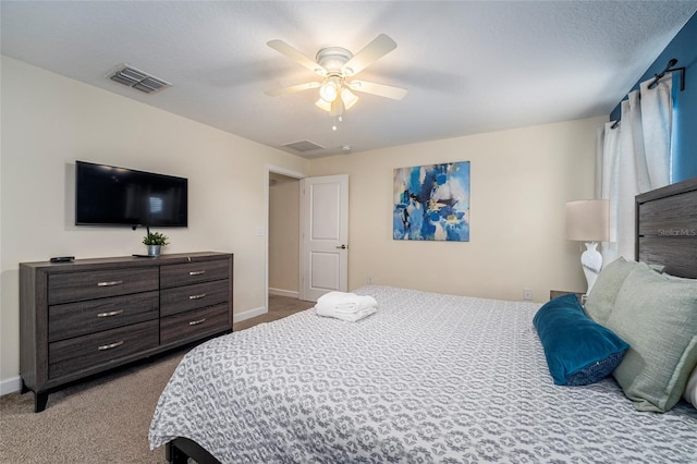 carpeted bedroom with a textured ceiling and ceiling fan