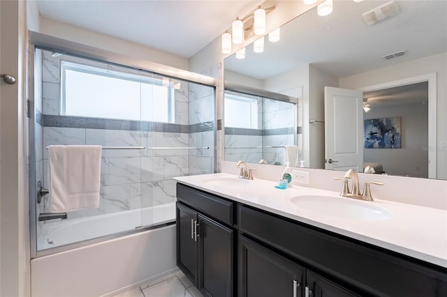 bathroom featuring vanity and bath / shower combo with glass door