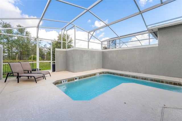 view of swimming pool featuring a lanai and a patio