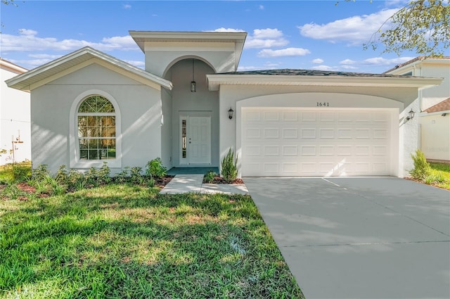 view of front of property with a front lawn and a garage