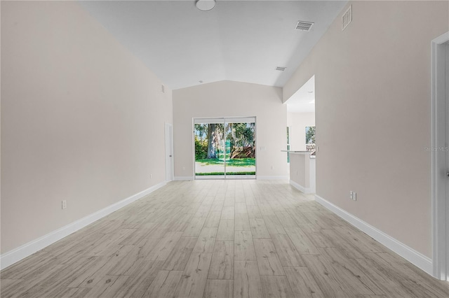 interior space featuring vaulted ceiling and light wood-type flooring