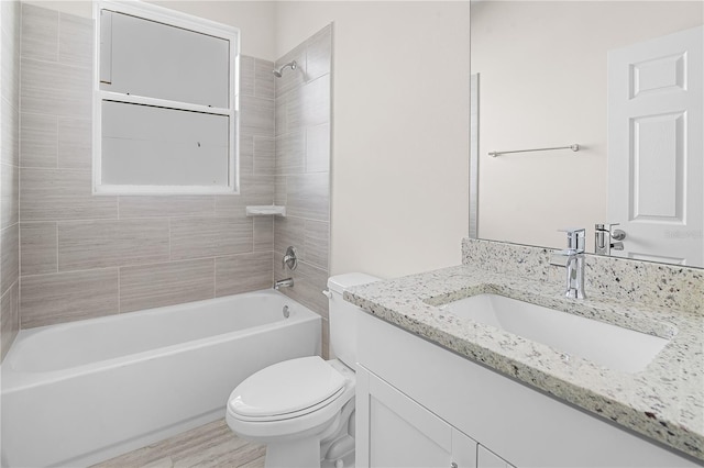 full bathroom featuring wood-type flooring, vanity, toilet, and tiled shower / bath