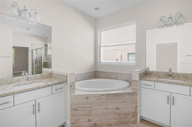 bathroom featuring separate shower and tub and vanity