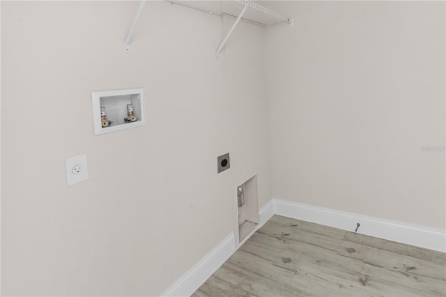 clothes washing area featuring hookup for an electric dryer, washer hookup, and light hardwood / wood-style flooring