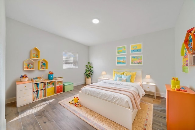 bedroom with hardwood / wood-style flooring