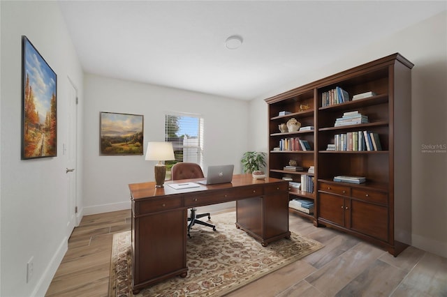 office with light wood-type flooring