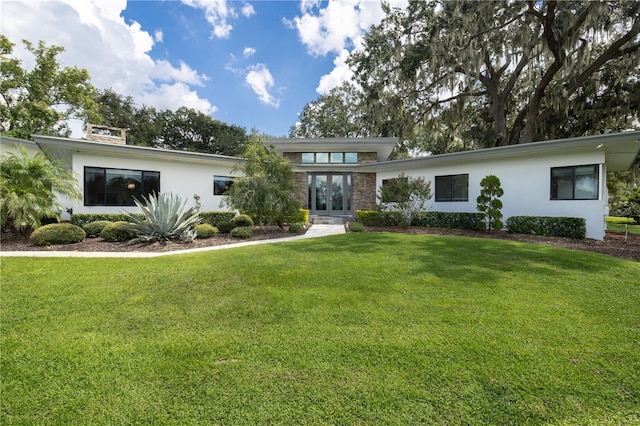 view of front of home featuring a front yard and french doors